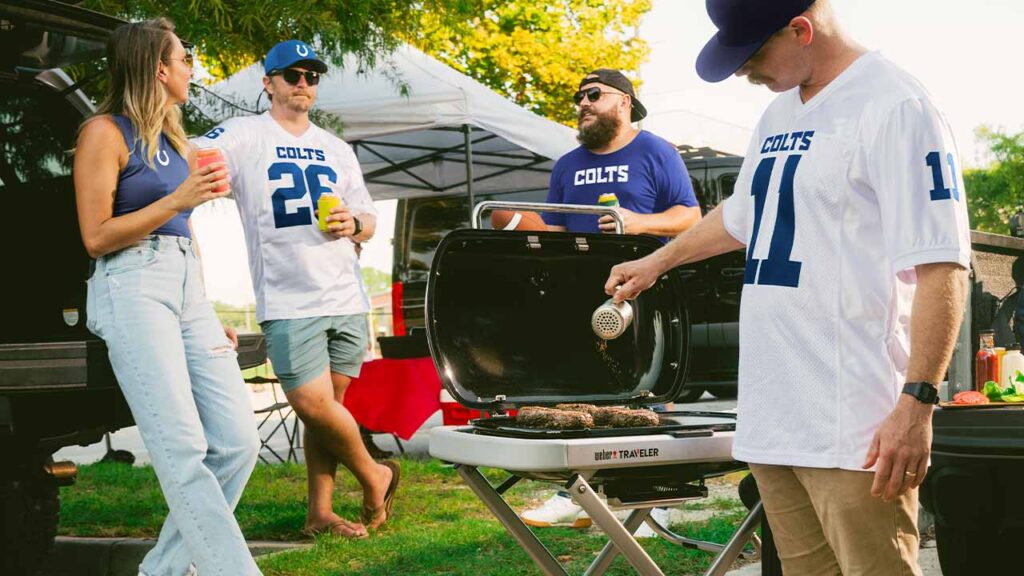 people grilling at a tailgating event