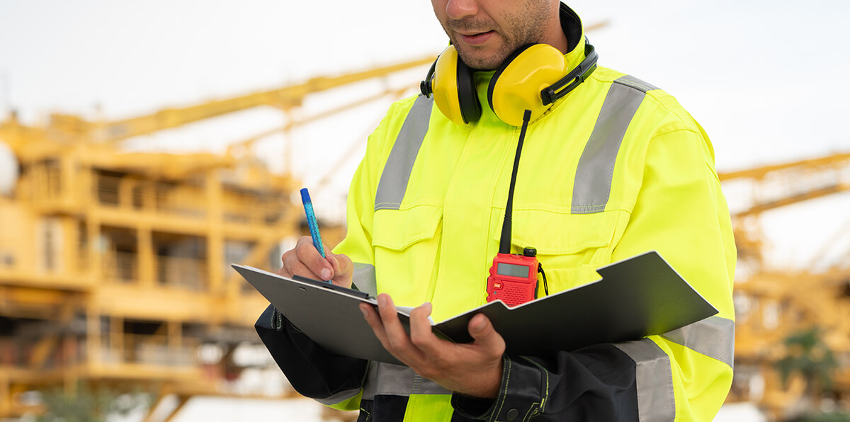 Contractor doing paperwork on a worksite